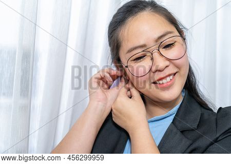 Close Up To Beautiful Asian Woman Face With Her Polite Glasses In Business Suit In Private Room.
