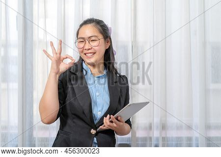 Ok Gesture Poses From An Asian Beauty Woman With A Tablet Computer, Mobile And A Control Telework Vi