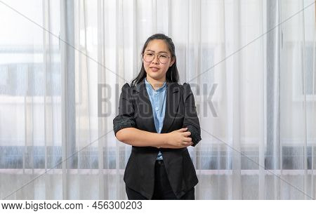 Little Entrepreneur Asian Eyeglasses Woman With Confident Pose In Black Suit Stands In Front Of Wind