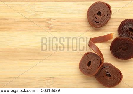 Fruit Pastille On Wooden Background. Fruit Roll-ups Made From Raspberry, Apples And Currant. Top Vie