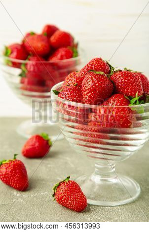Strawberries In Glass Cups On Light Background. Vertical Photo. Top View