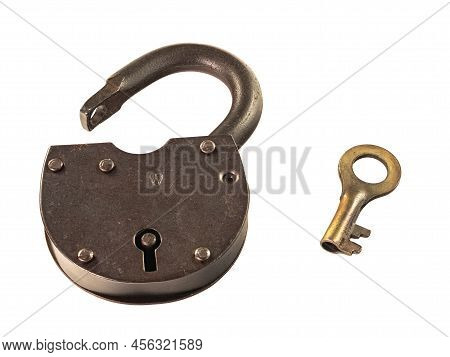 Old rusty padlock with a key is open isolated on a white background