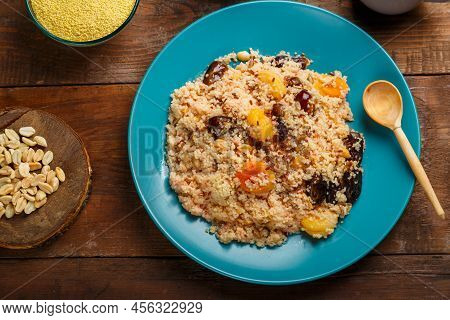 A Large Dish Of Couscous On A Wooden Table Next To Cereals In A Bowl Of Nuts And A Jug Of Fruit Brot