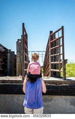 Mother And Child Looking At A Cattle Scute At The Feed Yard Scenic Overlook Outside Of Dodge City, K