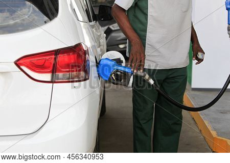 Salvador, Bahia, Brazil - May 17, 2022: Gas Station Attendant Fills Up With Gasoline And Vehicle At 