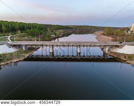 Beautiful View Of The Bridge Across The Iset River In The City Of Kamensk-uralsky At Sunset In Sprin