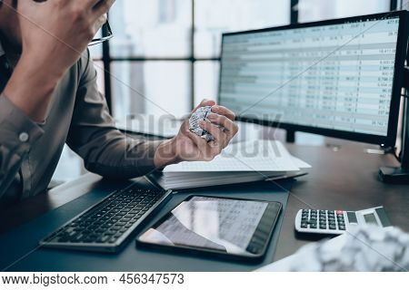 Serious Investors Have A Mad Crump Paper And Angry While Working  On The Desk.  Accounting And  Fina