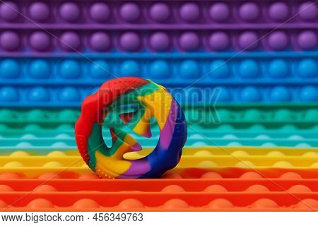 Trendy Rubber Educational Toy Snapperz On Background Of Colorful Silicone Toy Pop It. Selective Focu