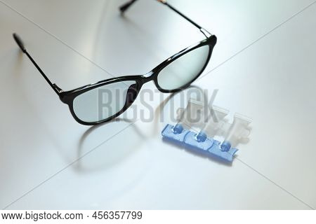 Single Dose Eye Drops And Glasses On White Table