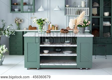 Kitchen Utensils, Dishes And Plate On Table. Green Kitchen Interior With Furniture. Stylish Cuisine 