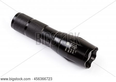 Modern Tactical Electric Led Flashlight In Black Fluted Metal Housing With Zooming Of The Light Beam