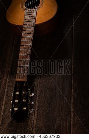 Classical Guitar On Dark Wood Background With Copy Space