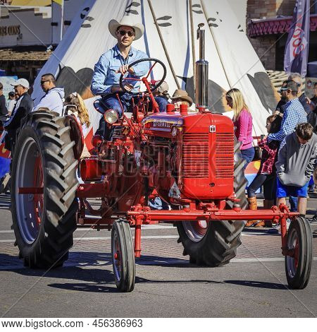 Scottsdale, Arizona, Usa - Farmer Riding A Vintage Farm Tractor Participating In The Scottsdale Para