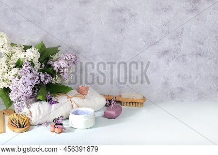 Spa And Wellness Composition With Lilac Flowers, Cream And Soap On A Light Background, Aromatherapy 