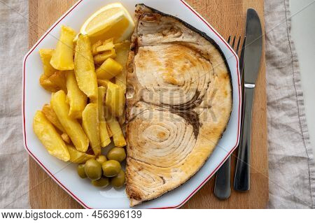 Seafood Dish, Grilled Steak From Swordfish Or Spada Served With French Fried Potatoes And Green Oliv