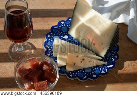 Spanish Hard Manchego, Cow, Sheep And Goat Cheeses Served Outdoor With Membrillo Jam And Glass Of Sh