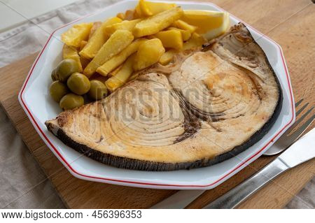 Seafood Dish, Grilled Steak From Swordfish Or Spada Served With French Fried Potatoes And Green Oliv