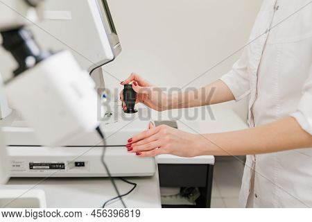 Doctor Examines Eyes On Screen Of Autorefractometer.