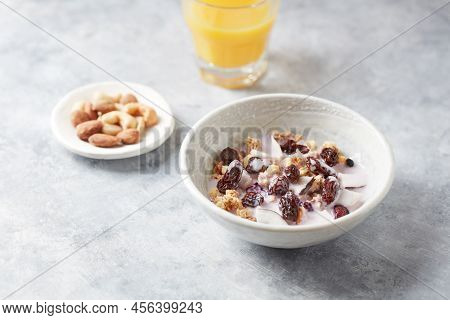 Bowl Of Granola With Yogurt, Nuts, Cranberry And Cocoanut. Concept For A Tasty And Healthy Meal. Sto