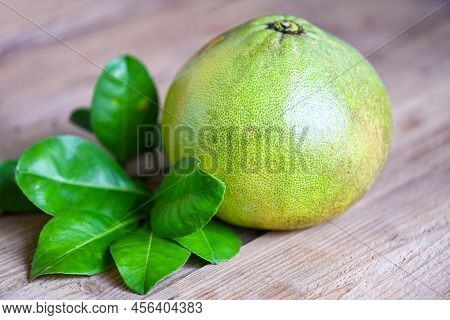 Pomelo Fruit On Wooden Background, Fresh Green Pomelo And Green Leaf Frome Pomelo Tree , Pummelo , G