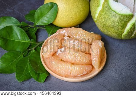 Pomelo Fruit And Dark Background, Fresh Green Pomelo Peeled On Plate And Green Leaf Frome Pomelo Tre