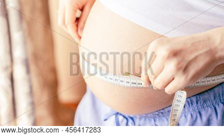 Measure Belly Pregnancy Woman. Happy Young Pregnant Woman With Tape Measuring Belly. Concept Materni