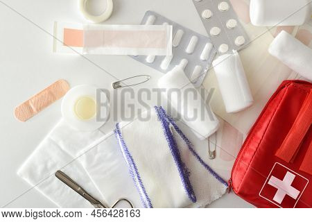 Assortment Of Emergency First Aid Kit On White Table. Horizontal Composition. Top View.
