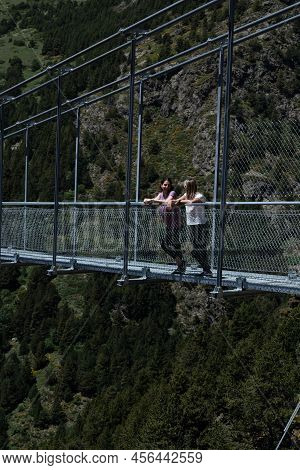 Canillo, Andorra. 2022 June 9. People Walking On The Longest Tibetan Bridge In Europe, 600 Meters Lo
