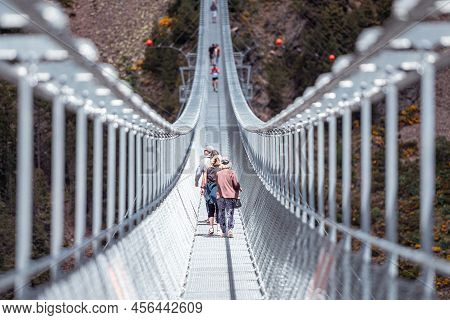 Canillo, Andorra. 2022 June 9. People Walking On The Longest Tibetan Bridge In Europe, 600 Meters Lo