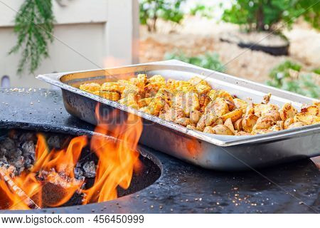 Vegan Cuisine: Slice Potatoes And Corn. Hot Bbq Charcoal Grill. Flames Fire Grill Background. Outdoo