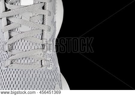New Unbranded Running Sneaker Or Trainer Isolated On Black Background. Men's Light Grai Sport Footwe