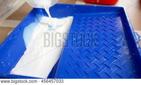A White Solution Is Poured Into The Baths To Grout The Seam Between The Tiles. The Plasterer Pours T