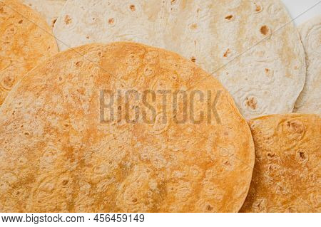 Tomato Flavored And Plain Wheat Tortilla Wraps. Spanish Or Mexican Circular Unleavened Flatbread Fro