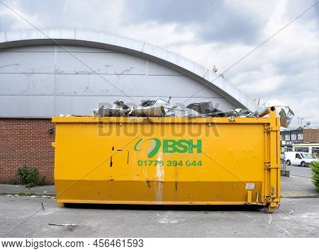 Grantham, Lincolnshire, England- June 7, 2022. Bsh  Big And Yellow Waste Container For Recycling At 