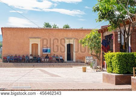 Teotitlan Del Valle, Oaxaca, Mexico- May 23, 2022: People Waiting Outside Of A Building At A Sunny D