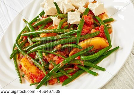 Fasolakia Lathera, Green Beans, Onion And Potatoes Stewed In Tomato, Herbs And Olive Oil On White Pl