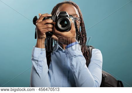 African American Young Adult Photography Entusiast With Modern Photographing Device Taking Photos On