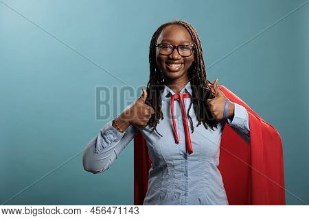 Positive Smiling Heartily Justice Defender Wearing Mighty Hero Red Cape While Giving Approve Sign. Y