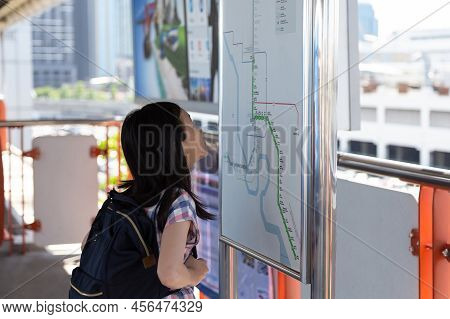 Asian Girl Orientating Herself On The Public Transport Map,student Looks At Maps With Public Transpo