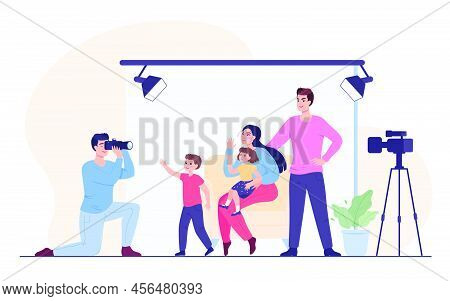 Parents And Kids Having Photo Session In Studio. Photographer Taking Photo Of Happy Mother, Father, 