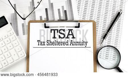 Paper With Tsa On Table With Charts, Business Concept