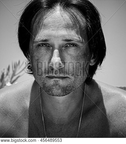 Portrait Of Naked Man Shoulders Under Sunshine. Calm Vies Of Stubble Man At Sun Day