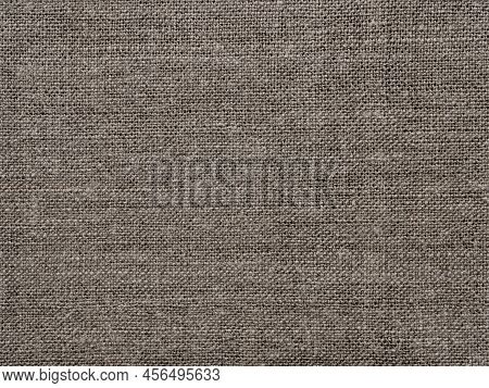 Brown linen fabric texture as background of intertwined threads