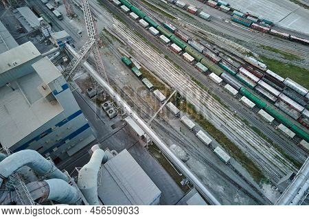 Aerial View Of Cargo Train Cars Loaded With Construction Goods At Mining Factory. Railway Transporta