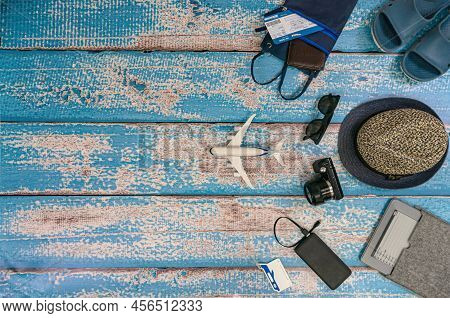 Man Vacation Accessories On The Blue Wooden Boards. Travel Hats, Camera, Glasses, Ticket Holder, Fli