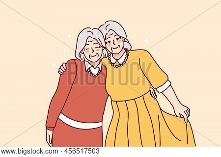 Happy Mature Grey-haired Women Hugging Enjoying Lifelong Friendship. Smiling Elderly Grandmothers Em