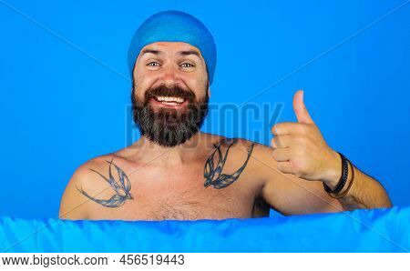 Happy Bearded Man In Shower Cap On Head Shows Thumb Up. Bath Time. Showering And Washing. Good Mood.