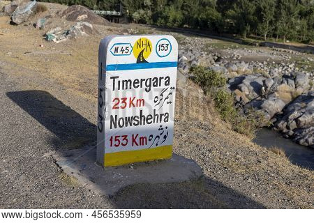 Dir, Kpk, Pakistan - June, 11, 2022: Concrete Signpost At Roadside To Give Distances Information