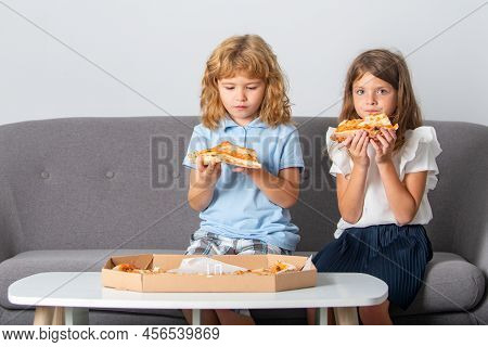 Pizza And Kids, Slices Pizza In Kids Hand. Children Eating Tasty Fast Food Pizza With Cheese. Happy 