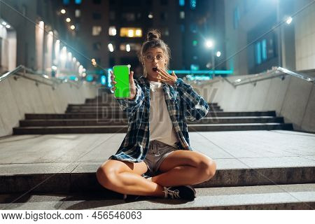 Woman Holding A Phone With A Chromakey On The Screen